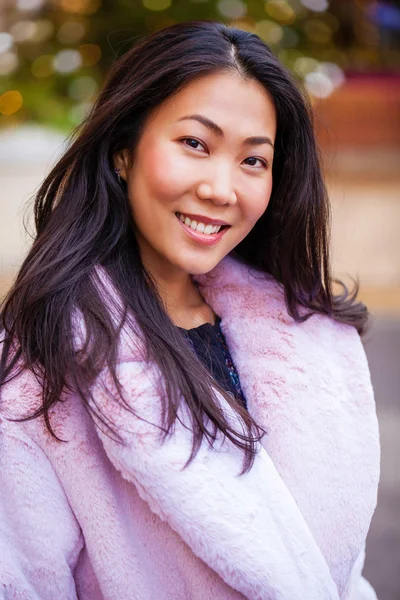 Happy asian woman in winter coat from faux fur — Stock Photo, Image