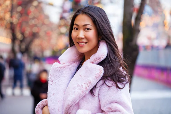 Happy asian woman in winter coat from faux fur — Stock Photo, Image