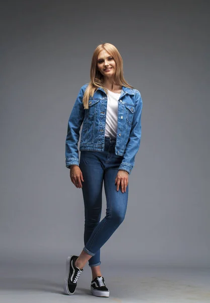 Сексуальная блондинка в джинсовой куртке и синем платье — стоковое фото