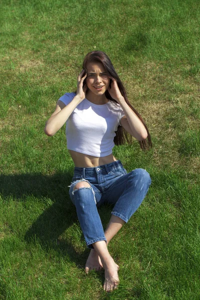 Portrait d'une jeune belle fille reposant sur la pelouse dans le pa — Photo
