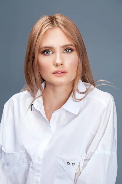 Closeup retrato de uma jovem bela mulher loira em um branco sh — Fotografia de Stock