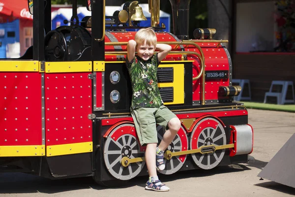 小男孩在蒸汽机车的背景上摆姿势，我 — 图库照片