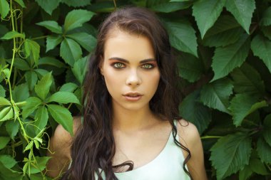 Yeşil sarmaşık yeşillik genç güzel bir kız portresi