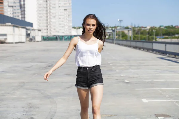 Bonita joven modelo morena en blusa de verano blanca y jeans, su — Foto de Stock
