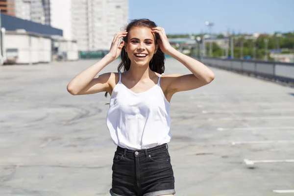 Mooie jonge brunette model in witte zomer blouse en jeans, su — Stockfoto