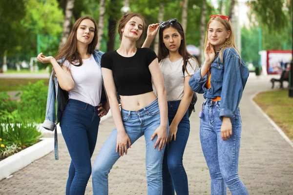 Four schoolgirls in summer park — Stock Photo, Image