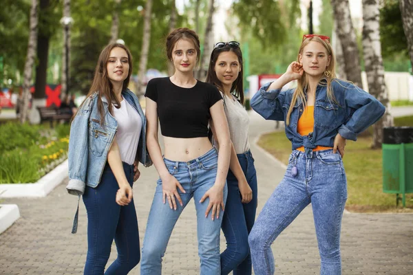 Four schoolgirls in summer park — Stock Photo, Image