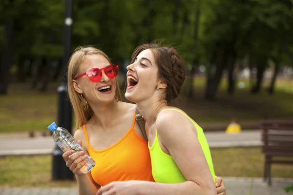 Two girlfriends walking on summer park, outdoors — Stock Photo, Image