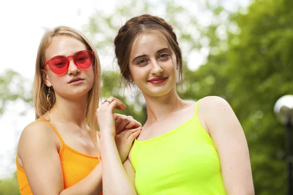 Two girlfriends walking on summer park, outdoors — Stock Photo, Image