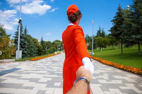 Follow Me, Young stewardess dressed in official red uniform of A — Stock Photo, Image