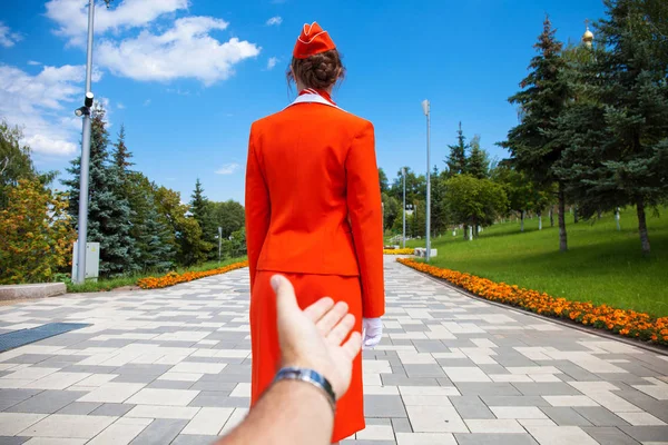 Follow Me, Young stewardess dressed in official red uniform of A — Stock Photo, Image