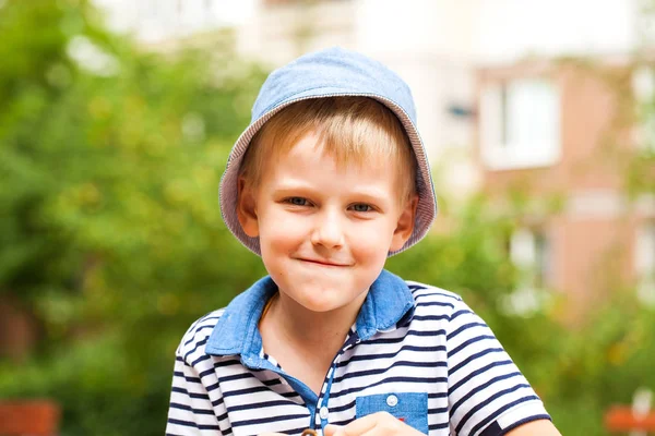 Portrait of a little blonde boy in a blue hat — Stock Photo, Image