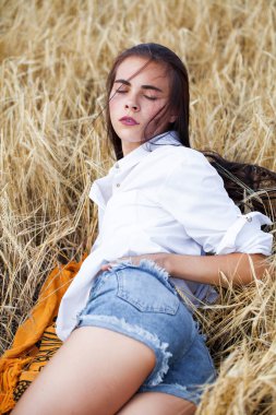 Beyaz gömlek ve mavi kot şort genç esmer kadın 