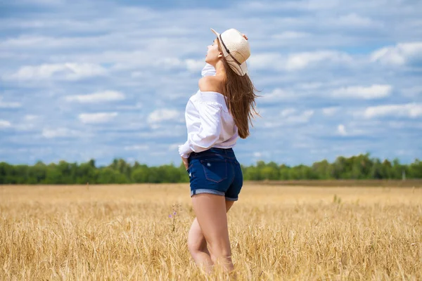 白いシャツと青いジーンズのショートパンツの若いブルネットの女性 — ストック写真