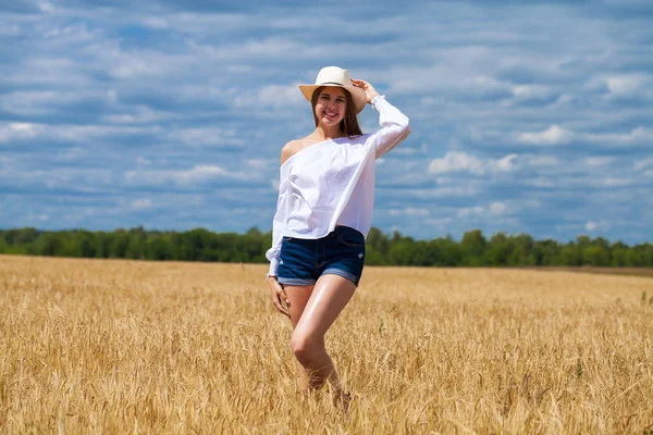 Young brunette woman in white shirt and blue jeans shorts — Stock Photo, Image