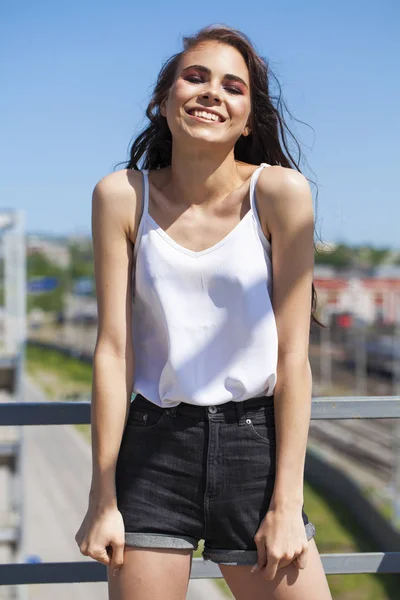 Smiling brunette model in white summer blouse, summer street out — Stock Photo, Image