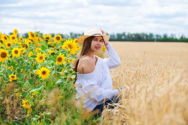 Brunette woman in white blouse sitting on a background of golden