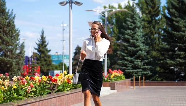 Young brunette woman calling by phone