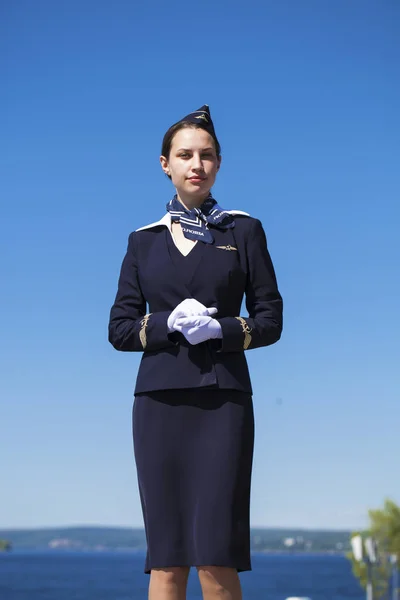 Beautiful stewardess dressed in official blue uniform