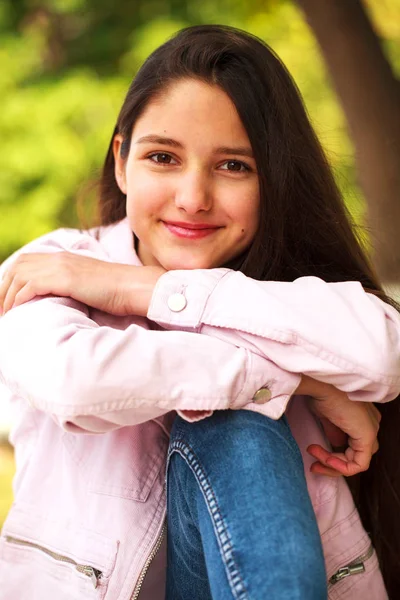 Portrait of a young girl in pink jacket on a background of autum — Stock Photo, Image