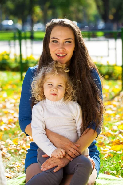 Closeup portrait of a young beautiful mother with little curly d — Stock Photo, Image