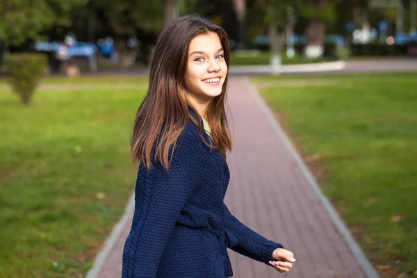 Mooie brunette klein meisje poseren in herfst Park achtergrond — Stockfoto