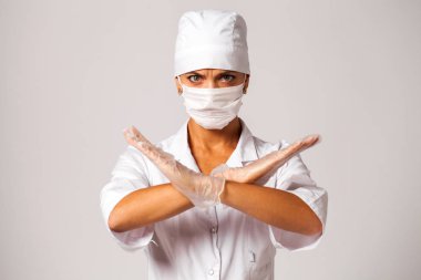 Gri arka plan üzerinde izole beyaz takım elbiseli hemşire