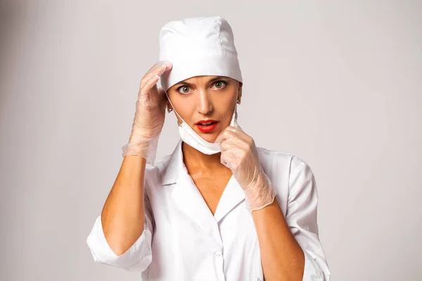 Nurse in a white suit isolated on gray background — Stock Photo, Image