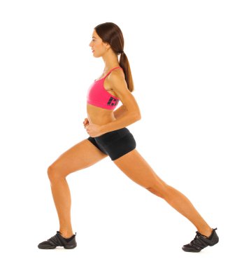 Genç sağlıklı kız egzersizleri yapıyor, tam uzunlukta portre izole