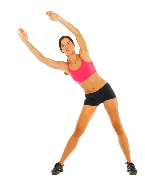 Young fitness brunette woman in red top and black shorts — Stock Photo, Image