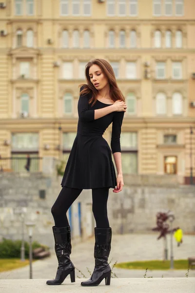 Retrato de una joven hermosa mujer en vestido negro posando en autum — Foto de Stock