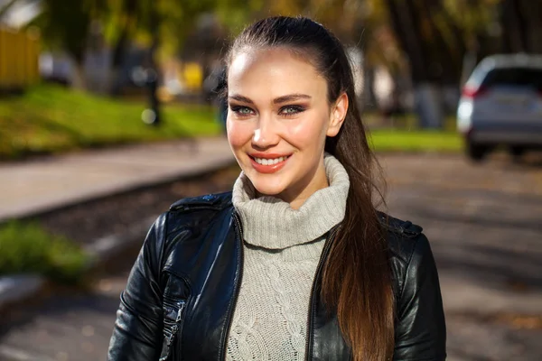 Young beautiful model in a black leather jacket — Stock Photo, Image