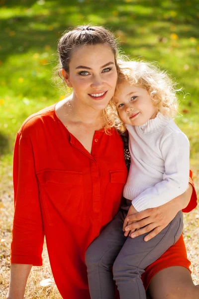 Closeup portrait of a young beautiful mother with little curly d — Stock Photo, Image