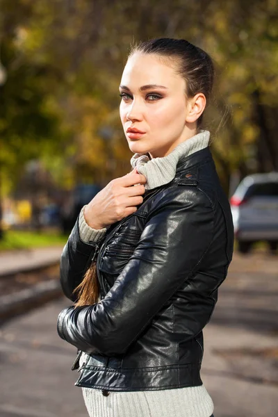 Young beautiful model in a black leather jacket — Stock Photo, Image