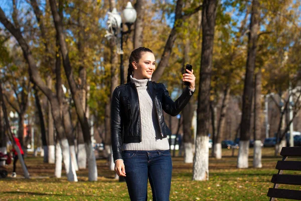 Young beautiful model in a black leather jacket — Stock Photo, Image