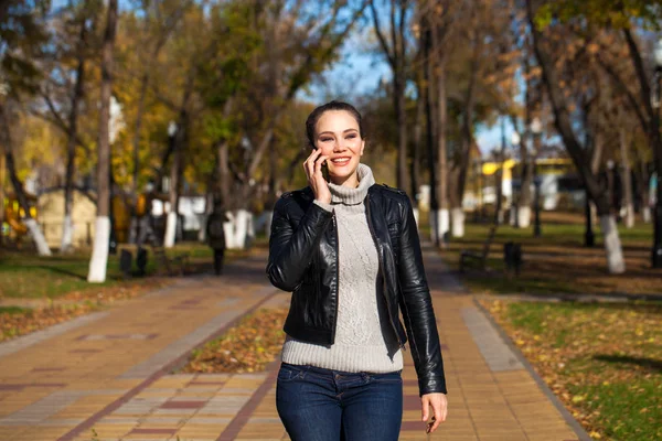 Young beautiful model in a black leather jacket — Stock Photo, Image