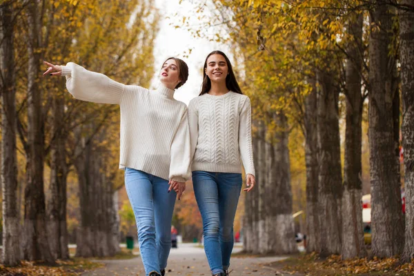 Two girlfriends in a white woolen sweater and blue jeans — Stock Photo, Image