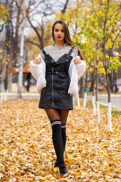 Portrait of a young beautiful woman in a white down jacket — Stock Photo, Image