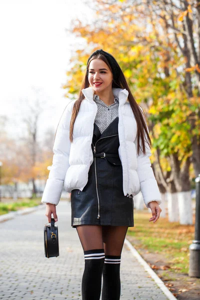 Portrait of a young beautiful woman in a white down jacket — Stock Photo, Image