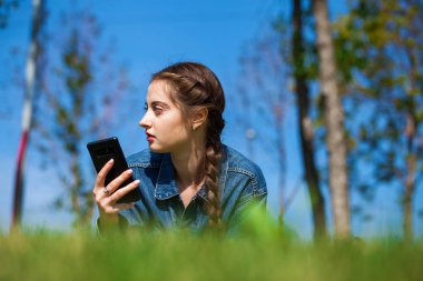 Yeşil çimenler üzerinde yatan güzel genç esmer kadın
