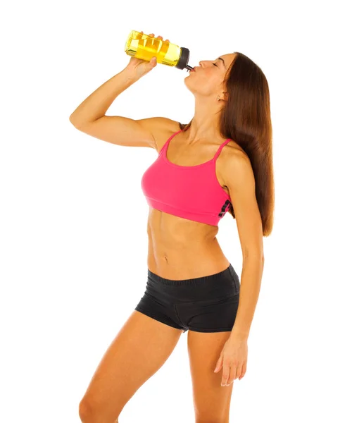 Menina atlética jovem bebe água de uma garrafa - isolado no whi — Fotografia de Stock