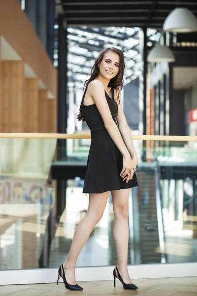 Full body portrait of a happy young brunette woman in black dres — Stock Photo, Image