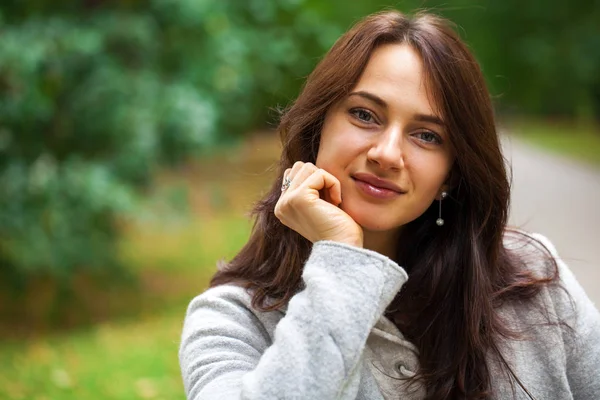 Portrait of a young beautiful woman in gray coat — Stock Photo, Image