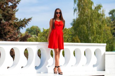 Seksi kırmızı elbiseli güzel esmer manken.