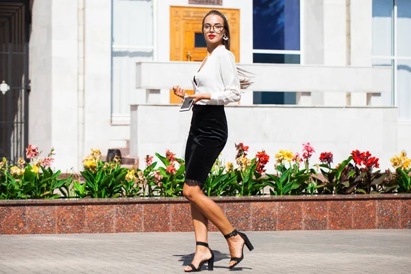 Business brunette woman walking in summer street