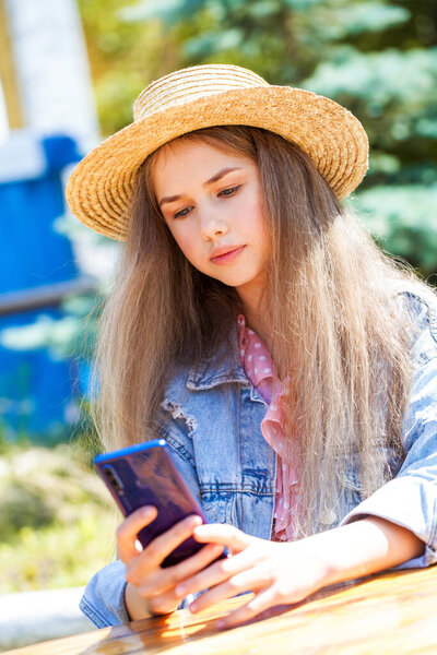 Young teenager girl with a mobile phone