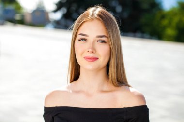 Yaz parkında genç ve güzel sarışın bir kadının portresi.