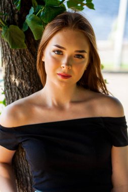 Yaz parkında genç ve güzel bir esmer kadının portresi.