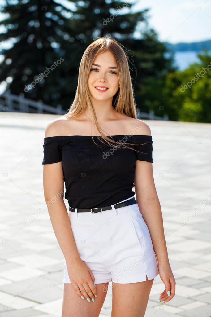Close up portrait of a young beautiful blonde woman in white shorts