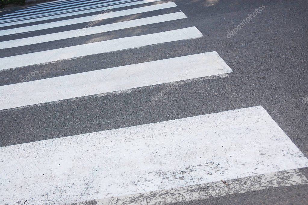 Empty white and gray crosswalk on asphalt road